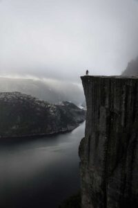 A person on a cliffside could use trauma counseling New York