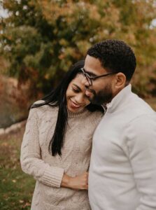 A happy couple in nature has a good relationship because they found trauma counseling NY