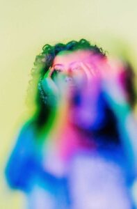 This woman with her hands on her head is the best trauma therapist New York
