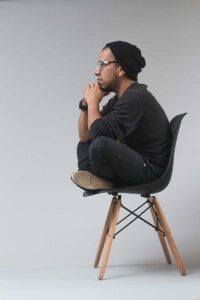 A man on a chair talking to a cbt psychologist near me