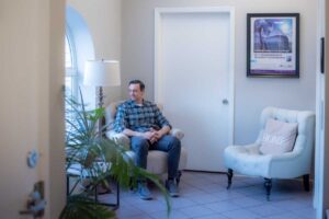 A man in Dr Vanessa Gomes' therapy waiting room where she provides depression counseling new york